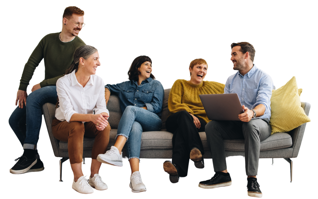 Five people sit and stand around a gray couch, laughing and talking together. One person holds a laptop, showcasing a workforce intelligence platform as the team discusses ways to boost team performance. Yellow pillows brighten the sofa. | Humanico Workforce Intelligence Software