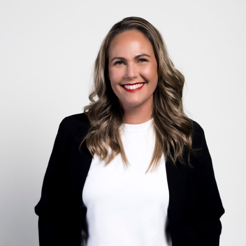 Fiona Vale, Co Founder Humanico, with long wavy hair, wears a black blazer over a white shirt and smiles confidently against a plain white background. | Humanico Workforce Intelligence Software